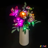 Light Kit for LEGO Pretty Pink Flower Bouquet #10342 displayed in a white vase with vibrant LED lights illuminating pink and orange flowers.